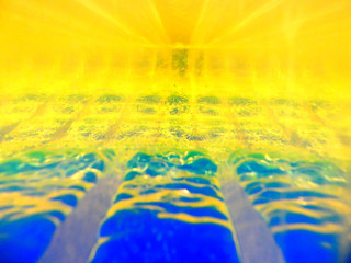 Abstract image of two fluids with different densities interacting with each other. Contains gold, blue colors, have perspective, selective focus. Reminds of the sunset or sunrise.