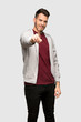 © luismolinero - Man with sweatshirt showing and lifting a finger over grey background