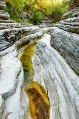 Papingo Rock Pools, also called ovires, natural green water pools located in small smooth-walled gorge near the village of Papingo in Zagori region, Greece.