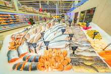 A Large Selection Of Fresh Fish Lying In The Ice On The Counter Of The Supermarket. 