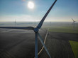 Aerial view of wind turbines and agricultural fields on a beautiful blue winter day - Energy Production with clean and Renewable Energy - aerial shot, analog image style