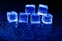 Blue Ice Cubes On Black Background.