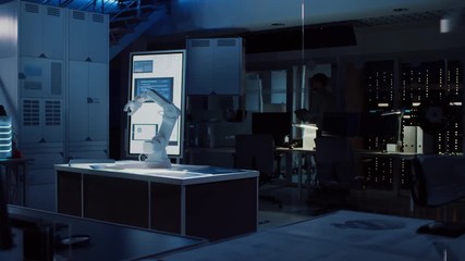 Leinwandbilder - In Industrial Robot Desing Research Laboratory: Robotic Arm Prototype Standing Illuminated on the Desk. In the Dark Background Various High Tech Devices, Computers, Digital Whiteboard and Blueprints