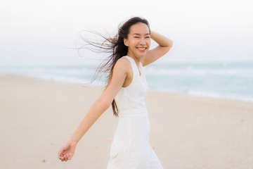 Portrait beautiful young asian woman happy and smile on the beach sea and ocean