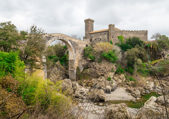 Wall Mural - Vulci (Italy) - The medieval castle of Vulci, now museum, with Devil's bridge. Vulci is an etruscan ruins city in Lazio region, on the Fiora river between Montalto di Castro and Canino.