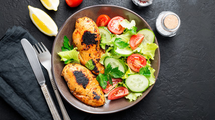 Wall Mural - Grilled chicken breast. Fried chicken fillet and fresh vegetable salad .