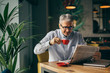 © cherryandbees - coffee break. man drinking coffee and reading newspaper in cafe bar