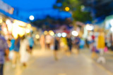 Fototapeta Zachód słońca - Abstract blurred people walking on market with light of bokeh