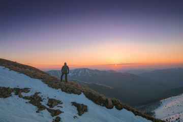 Man enjoy the sunset in a mountains