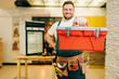 © Nomad_Soul - Repairman in uniform holds toolbox, handyman