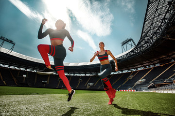 Wall Mural - Strong athletic woman sprinter, running on stadium wearing in sportswear. Fitness and sport motivation. Runner concept.