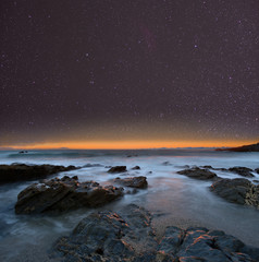Wall Mural - night sky from a rocky beach. cornwall, uk.