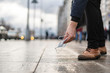 © Mihail - person pick up dropped trash in the streets