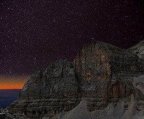 Wall Mural - night sky over the mountains. the dolomites in modonna di campiglio, italy.