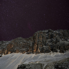 Wall Mural - night sky over the mountains. the dolomites in modonna di campiglio, italy.