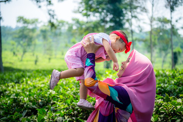 a happy muslim mother with her daughter have fun at tea farm in java indonesia