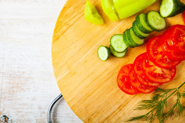 Sliced vegetables for salad on a cutting board.