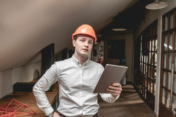 young businessman in hard hat helmet  work in building company