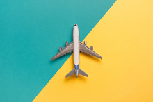 Flat Lay Airplane On Yellow And Blue Background