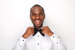 © mimagephotos - happy african american man adjusting bowtie