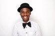 © mimagephotos - Close up cool african american man smiling with bowtie and hat