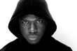 © mimagephotos - black and white portrait of young black man with hoodie