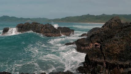 Wall Mural - Slow motion shot of big sea waves crashing against the rocks. Waves crashing and hitting on the rocks at the sea. Palawan island, Philippines. Beautiful scenic nature landscape. S Travel concept.