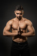 © inarik - Athlete Man Studio Portrait, Sexy Sportsman Naked Body Concentrating with Folded Hands over Black Background