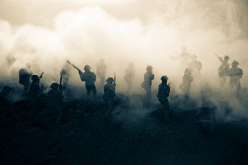 War Concept. Military silhouettes fighting scene on war fog sky background, World War Soldiers Silhouettes Below Cloudy Skyline At night. Attack scene. Armored vehicles. Tanks battle. Decoration