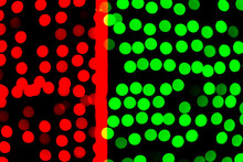 Unfocused Abstract Green And Red Bokeh On Black Background. Defocused And Blurred Many Round Light