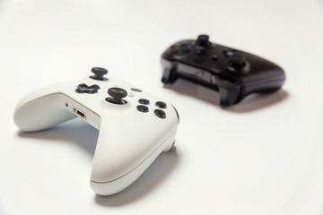 White and black two joystick gamepad, game console isolated on white background. Computer gaming technology play competition videogame control confrontation concept. Cyberspace symbol