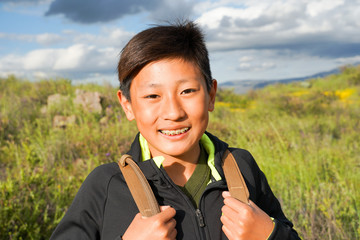 young sporty asian boy enjoying & hiking the mountain during the california golden poppy and goldfie