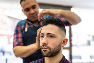 Wall Mural - Young Man Getting a Hairstyle in a Barbershop.