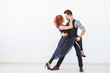 © satura_ - Social dance, kizomba, tango, salsa, people concept - beautiful couple dancing bachata on white background with copy space