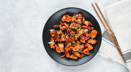 Wall Mural - spicy chicken in sweet and sour sauce with chili pepper. teriyaki chicken's  with  sesame seeds. Chinese cuisine, Thai cuisine. Japanese food, copy space, recipe background, food flat lay