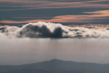 Beautiful sunreise on the hill above clouds and its raining