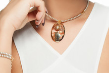 Woman Neck In Gold Necklace With Pearls And Cameo Pendant Closeup