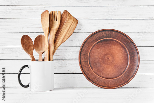 Cooking Utensils In Cup And Brown Plate On White This