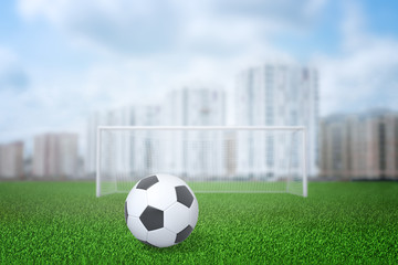 Wall Mural - 3d rendering of football ball, gate and field with city buildings on the background