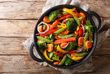 Healthy Asian food stir fry of vegetables with sesame close-up in a bowl, horizontal top view
