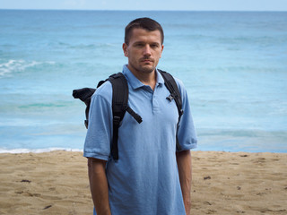 A man on the beach. Atlantic ocean background.