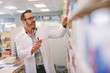 © Jacob Lund - Pharmacist looking for medicine in the store
