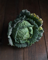 whole uncooked cabbage on classic wooden board