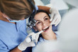 © Yakobchuk Olena - Charming young woman receiving dental treatment at clinic