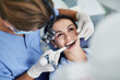 Charming young woman receiving dental treatment at clinic