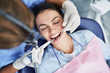 © Yakobchuk Olena - Charming young woman receiving professional teeth cleaning at clinic