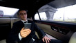 © motortion - Pensive businessman writing e-mail, riding in car, stressful job, workaholic