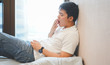 © chinnarach - close up asian man sleepy and yawning at bedroom in vacation day