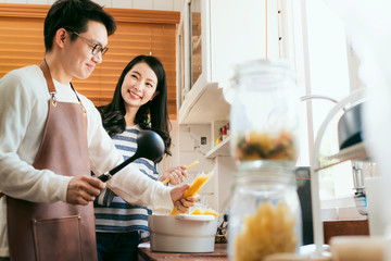 Wall Mural - Attractive Asian couple marry family  preparing cooking food dinner together with happiness and freshful in home kitchen family ideas concept