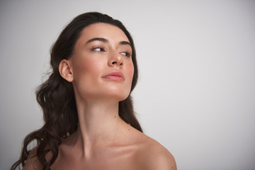 Young graceful pretty brunette woman on white